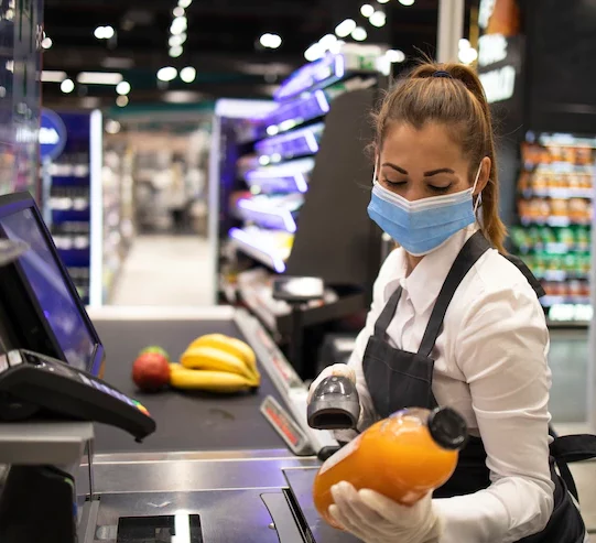 cashier-supermarket-wearing-mask-gloves-fully-protected-against-corona-virus_342744-1079