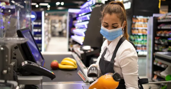 cashier-supermarket-wearing-mask-gloves-fully-protected-against-corona-virus_342744-1079